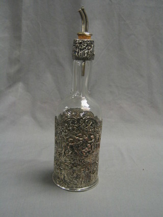 A glass bottle complete with "Dutch" pierced "silver" bottle holder and rim