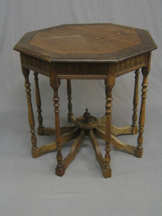 An Edwardian octagonal oak occasional table, raised on turned supports 26" (top scratched)