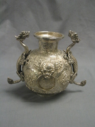 A handsome embossed Eastern silver twin handled urn of globular form with dragon handles, 26 ozs