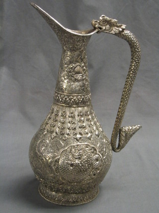 An embossed Eastern silver ewer with serpent handle 28 ozs