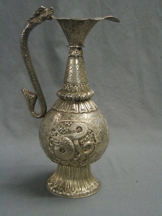 An embossed Eastern silver ewer with serpent handle, 29 ozs