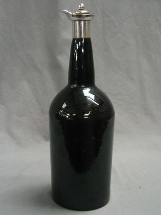 An antique green glass wine bottle with silver neck Chester 1902