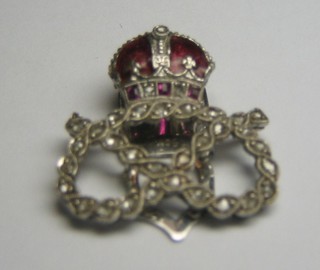 A 9ct white gold and enamelled dress clip in the form of the Royal Staffordshire Regt Cap badge, set numerous diamonds (reputedly a gift at the Coronation)