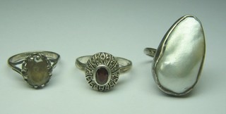 A silver dress ring set a tear drop shaped "pearl" and 2 silver dress rings