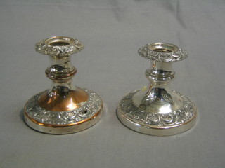 A pair of circular embossed silver plated stub candlesticks 3" (1 with hole)