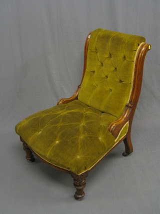 A Victorian mahogany show frame nursing chair upholstered in green buttoned material