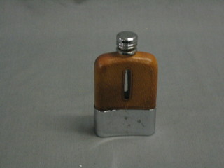 A small spirit hip flask with leather mounts and chromium plated cup