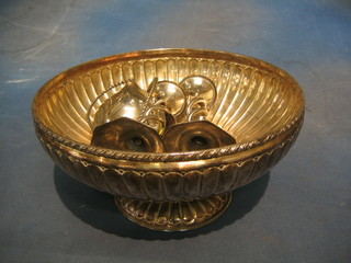 A circular embossed silver plated bowl 11", a pair of silver plated candlesticks 14" and various boat shaped dishes