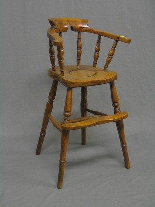 A childâ€™s 19th Century elm high captain's chair