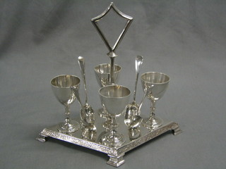 A 4 piece silver plated egg cruet complete with spoons
