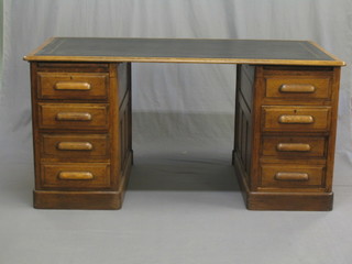 An Edwardian oak pedestal desk with black inset tooled leather writing surface, the pedestals fitted 6 long drawers 60"