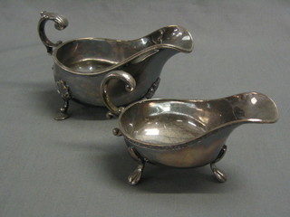 A large silver plated sauce boat with C scroll handle together with 1 other (2)