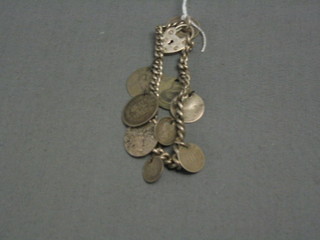 A silver curb link charm bracelet hung 9 silver coins with padlock clasp