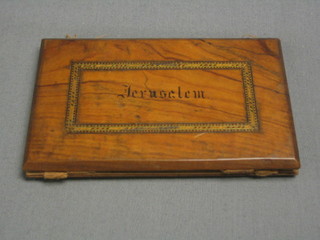 An olive wood wallet marked Jerusalem, 5"