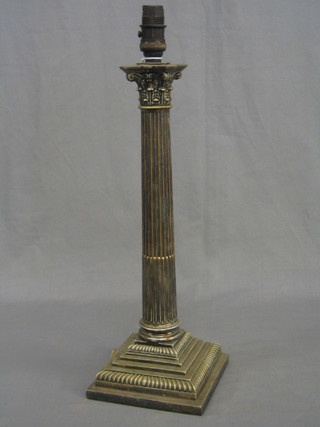 A silver plated Corinthian column table lamp, raised on a stepped base 17"