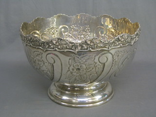 A reproduction Georgian embossed silver plated punch bowl raised on a circular spreading foot 14"