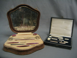 An ivory 7 piece manicure set and a 1950's manicure set, cased