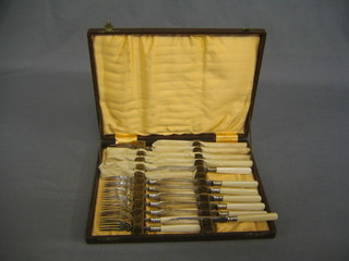 A set of 12 fish knives and forks, cased