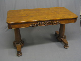 A Victorian rectangular rosewood library table, the carved frieze fitted a drawer, raised on turned supports, 51"