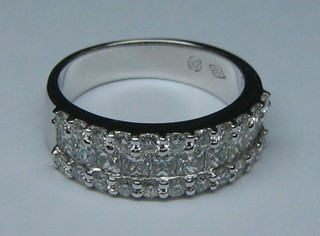 A lady's 18ct white gold half eternity dress ring, set 11 diamonds, supported by numerous other diamonds (approx 1.45ct)