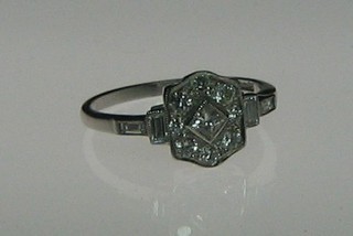 A lady's Art Deco style white gold dress ring set diamonds and 4 baguette cut diamonds to the shoulders (approx 0.48ct)