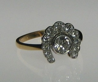 A lady's 18ct gold dress ring in the form of a horse shoe set 12 diamonds (approx 0.90ct)