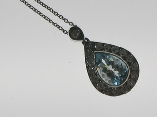 A lady's 18ct white gold pendant set a tear drop aquamarine surrounded by diamonds, hung on a fine gold chain (approx 0.71ct)
