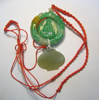 A carved jade coloured pendant and 1 other
