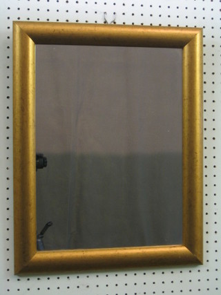 A rectangular plate mirror contained in a decorative gilt frame 19" x 15"
