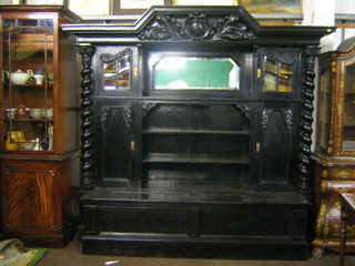 A handsome German ebonised and carved oak chiffonier sideboard, the carved raised back fitted a niche, flanked by cupboards enclosed by panelled doors, the base fitted a box with hinged lid flanked by a pair of spiral turned columns with Corinthian capitals 75"