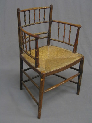 A 19th Century faux bamboo  carver chair with woven rush seat (screws visible to arms)