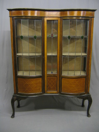 An Edwardian inlaid mahogany display cabinet, fitted adjustable shelves enclosed by lead glazed panelled doors, raised on cabriole supports 47"