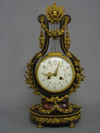 A handsome 19th Century French 8 day striking mantel clock with porcelain dial, Arabic numerals, contained in a simulated rosewood and gilt Ormolu lyre shaped case by Maple & Co Ltd Paris