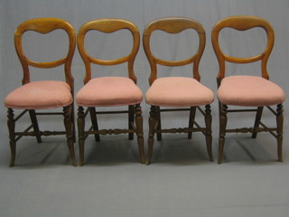 A set of 8 Victorian mahogany balloon back bedroom chairs with shaped mid rails, raised on turned supports