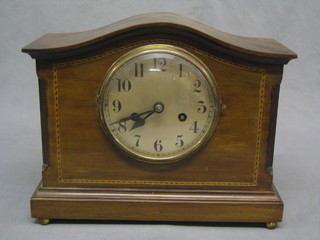 An Edwardian 8 day mantel clock with silvered dial contained in an arched inlaid mahogany case