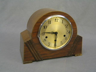 A 1930's chiming 8 day mantel clock with silvered dial and Arabic numerals contained in an arch shaped case