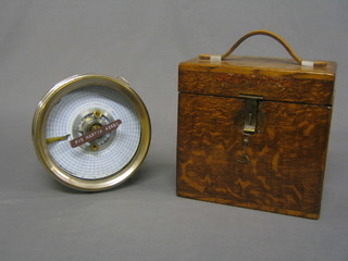 A racing pigeon clock by the Automatic Timing Clock Co. contained in a chromium plated case complete with oak carrying box