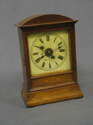 A 19th Century Winterhalder& Hoffman Continental 8 day striking alarm clock the painted dial with Roman numerals contained in an inlaid mahogany arch shaped case