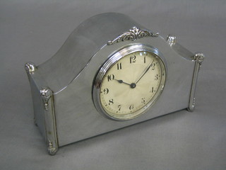 A 1930's 8 day bedroom timepiece with silvered dial contained in an arched chromium plated case