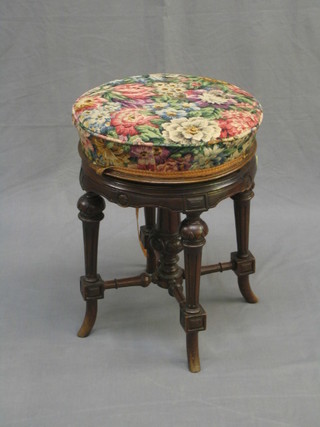 A Victorian circular carved walnut revolving adjustable piano stool