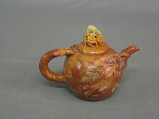 An Oriental carved soap stone tea pot, decorated flowers and ferns with eagle to the top 4"