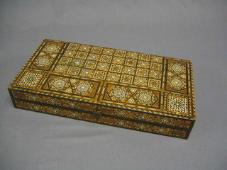 A 20th Century Eastern inlaid backgammon set together with dice and pieces