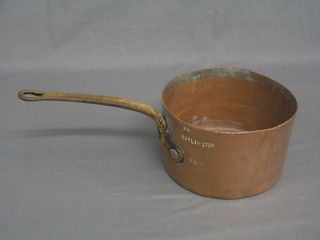 A copper saucepan marked Burlington, with iron handle