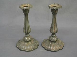 A pair of pewter candlesticks with petal bases  9 1/2"