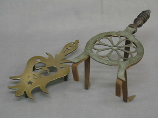 A pierced brass and iron stand and a trivet