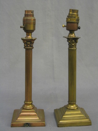 A pair of brass reeded table lamps with Corinthian capitals, raised on stepped bases 10"