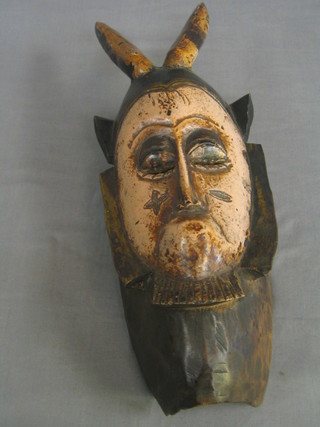 A carved Eastern wall mask