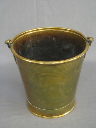 A circular brass pail with swing handle 10"