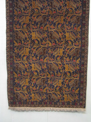A contemporary Afghan Belouch rug decorated stags amidst trees 74" x 44"