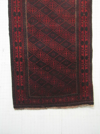 A contemporary red and geometrically patterned Meshad rug 75" x 40"